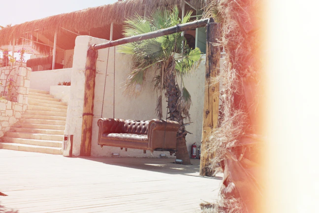 Sunlit terrace featuring a sleek Terraluxe sofa set with plush cushions and natural wood accents.