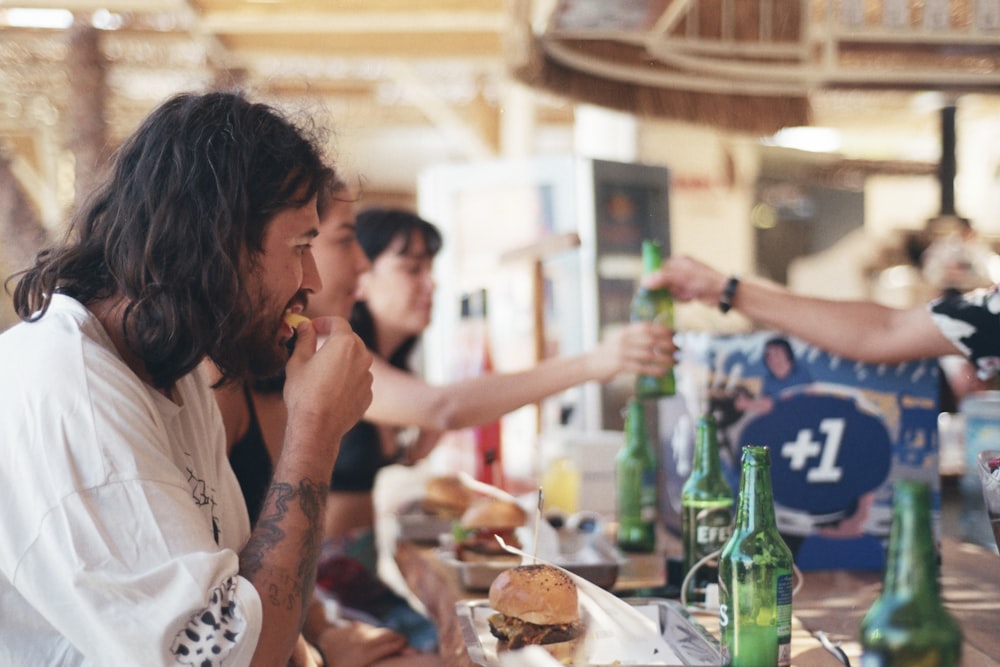 a group of people sitting at a table eating food