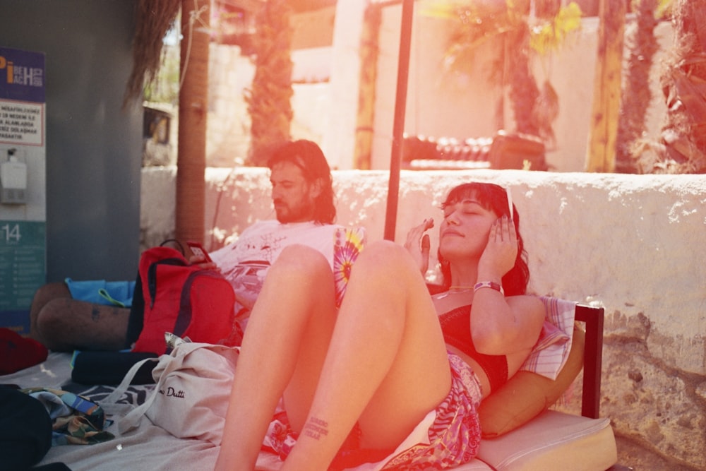 a man and a woman sitting on a bench next to each other