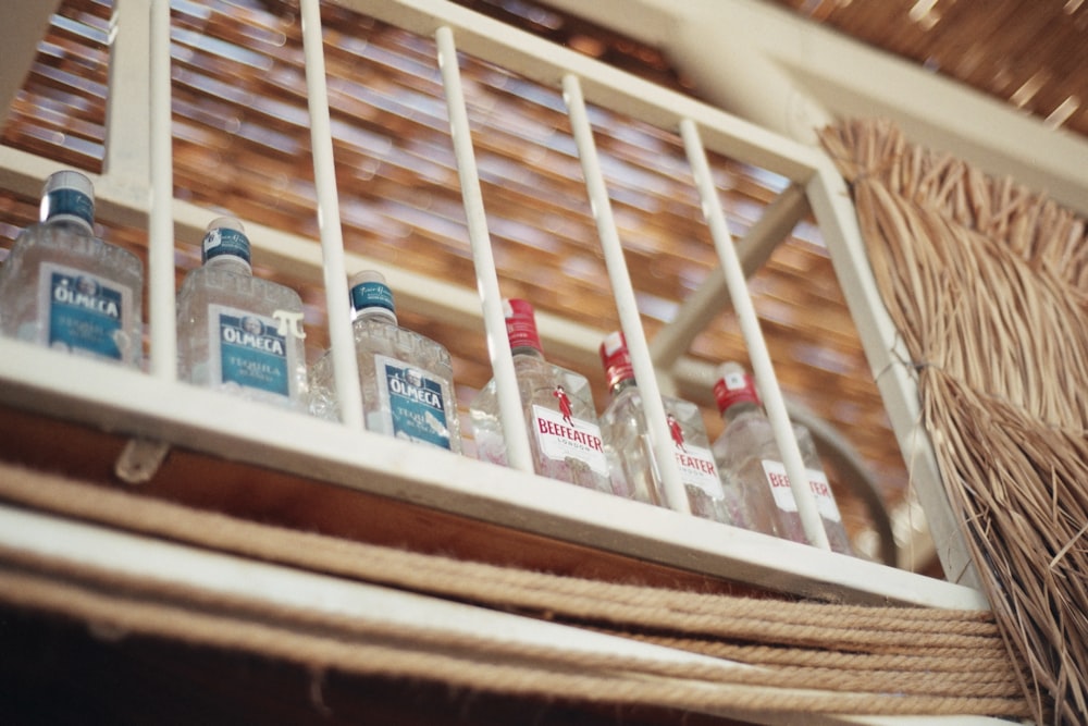 bottles of water are lined up on a shelf