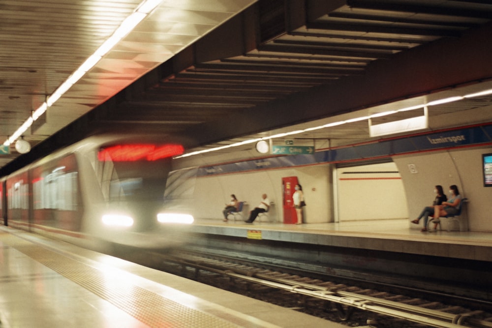 a train pulling into a train station next to a platform