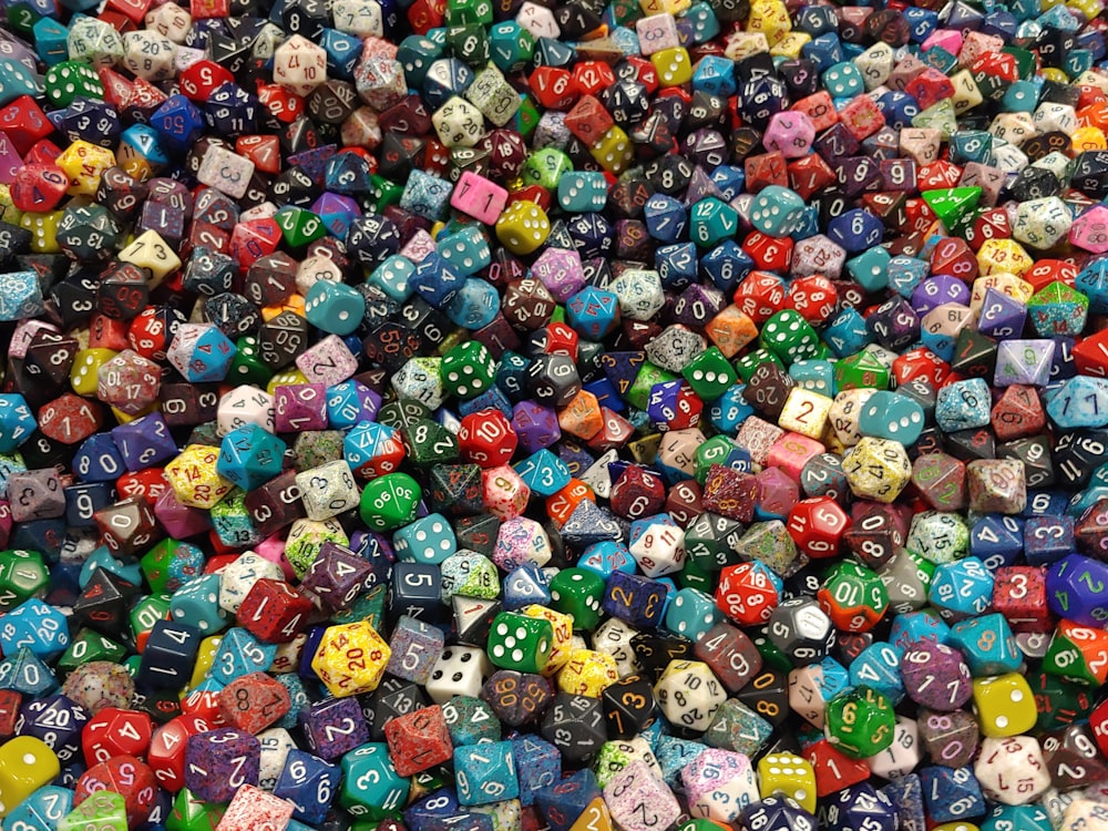 a pile of colorful dice with numbers on them