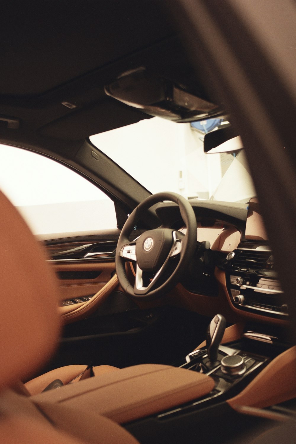 the interior of a car with a steering wheel and dashboard