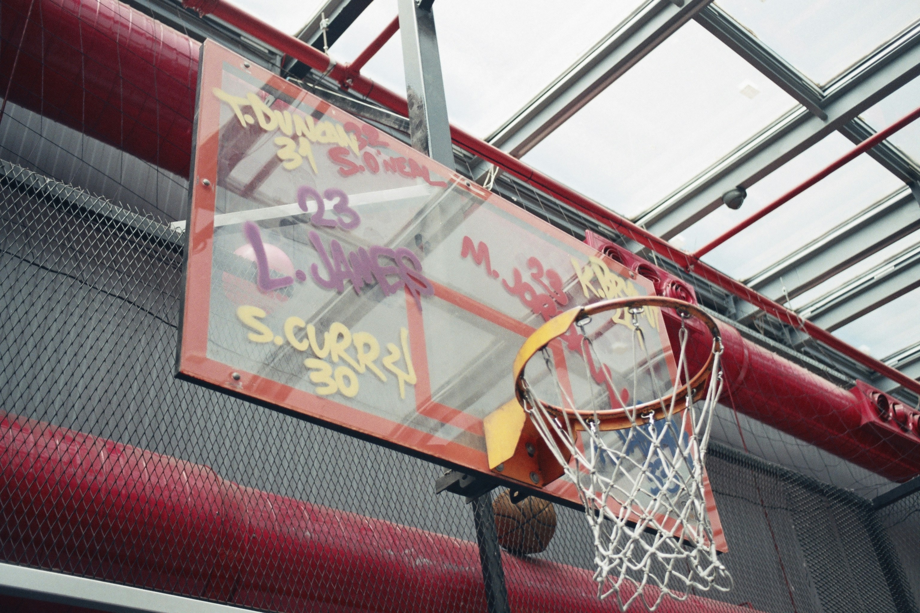 a basketball hoop with graffiti on the back of it