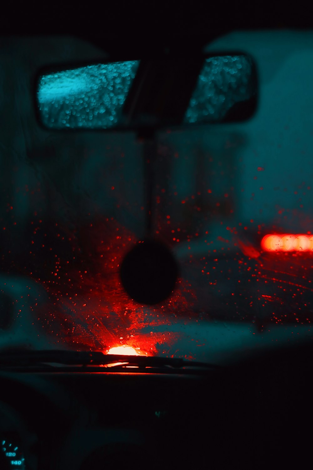 a rear view mirror of a car with rain on it