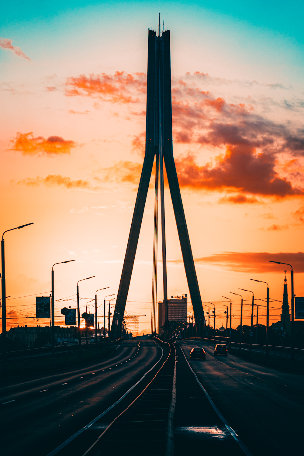 the sun is setting behind a tall tower