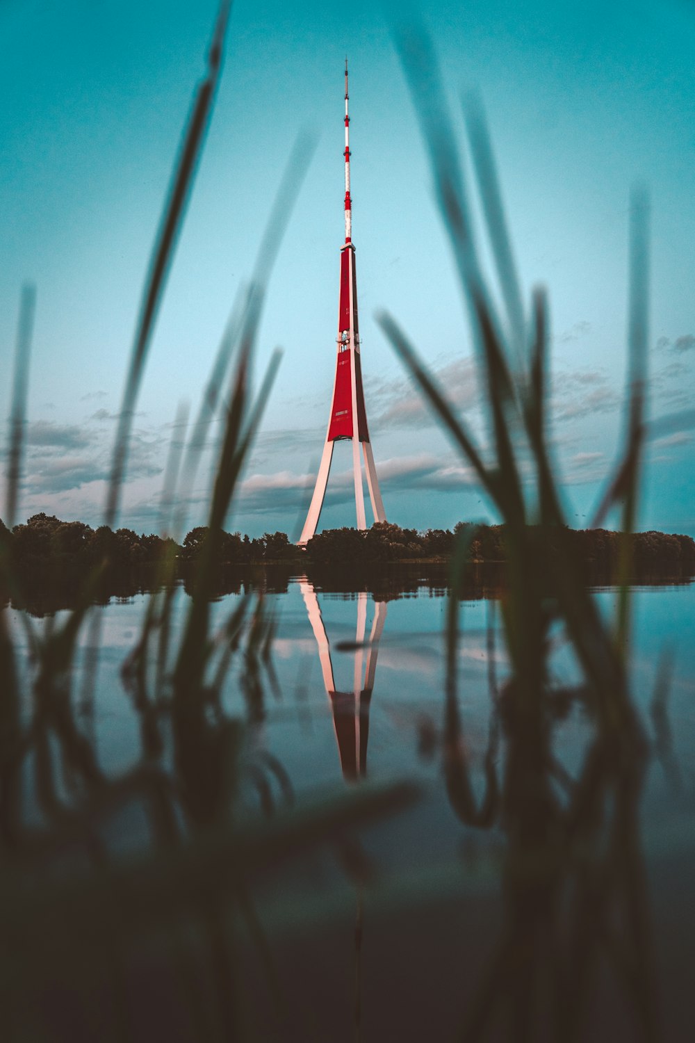 a very tall tower sitting in the middle of a lake