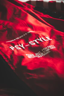a close up of a red jacket with white writing on it