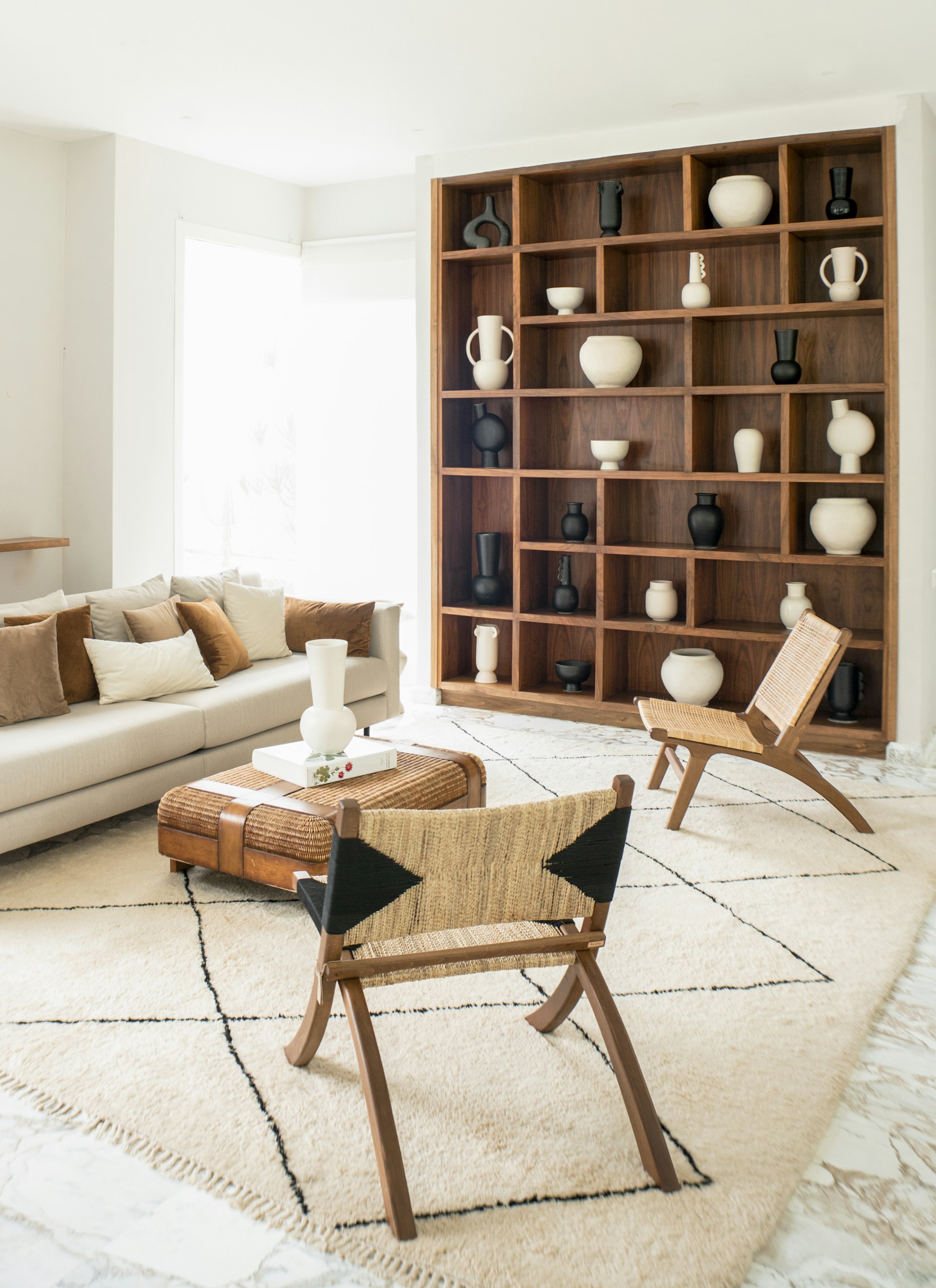 a living room filled with furniture and a book shelf