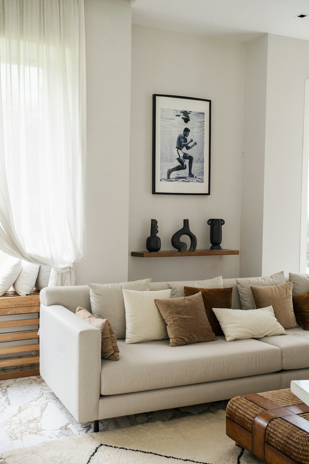 a living room filled with furniture and a painting on the wall