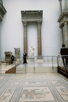 a group of people standing around a museum