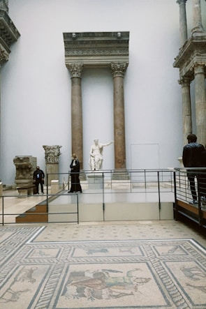 a group of people standing around a museum