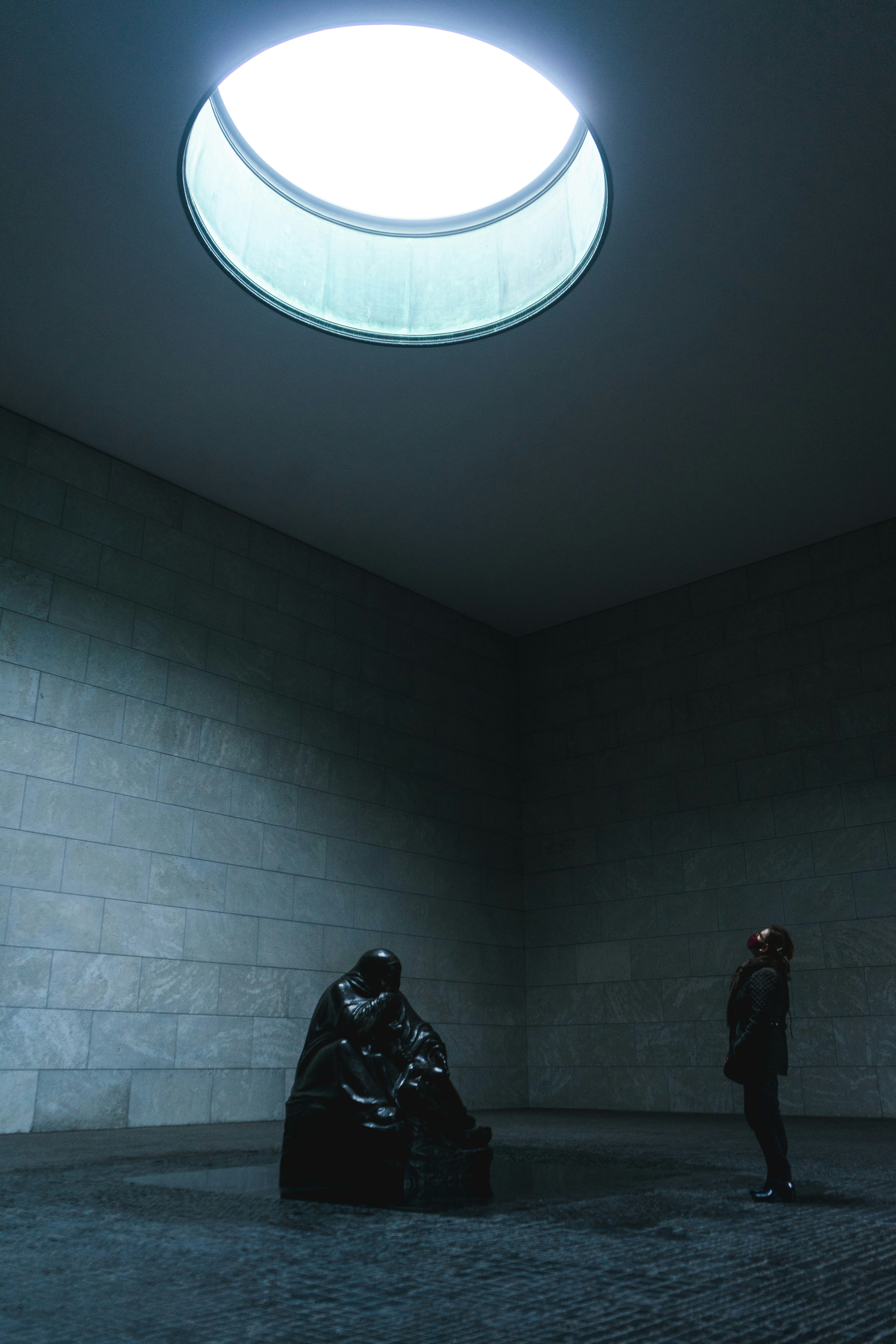 a person standing in a room with a skylight