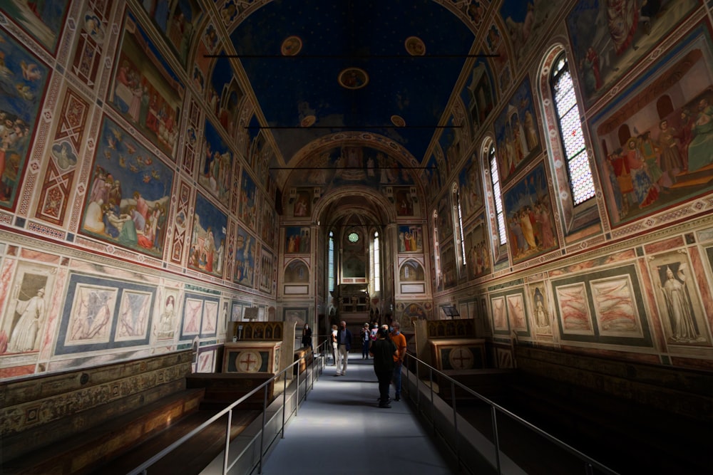 a long hallway with many paintings on the walls