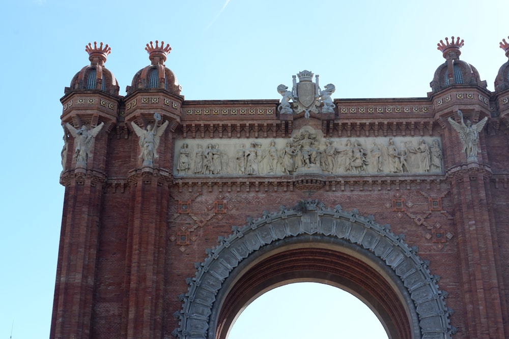 a very tall brick arch with statues on it