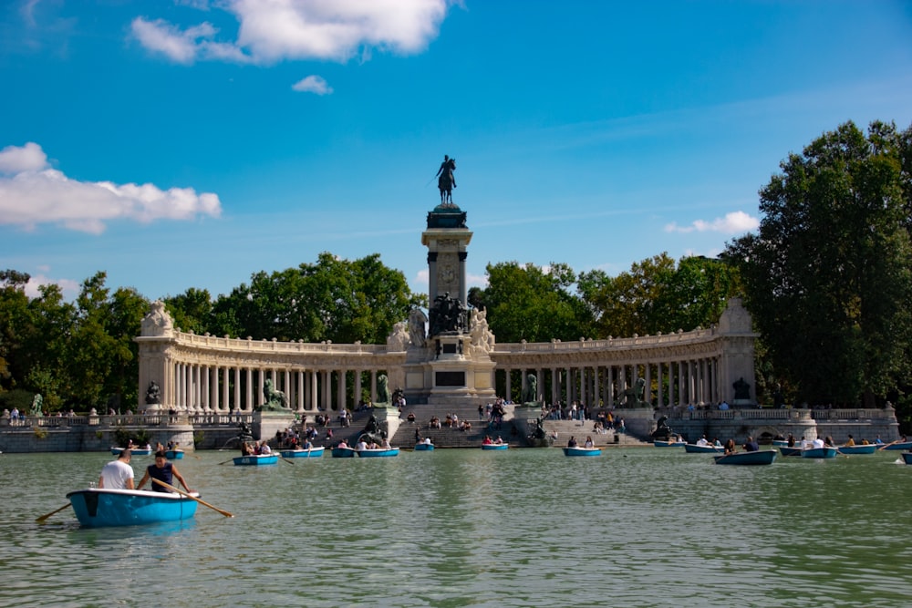 a group of people in a row boat on a lake