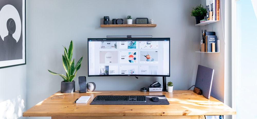 a computer monitor sitting on top of a wooden desk