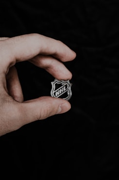 a person holding a badge in their hand