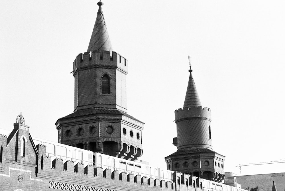 a black and white photo of two towers on a building