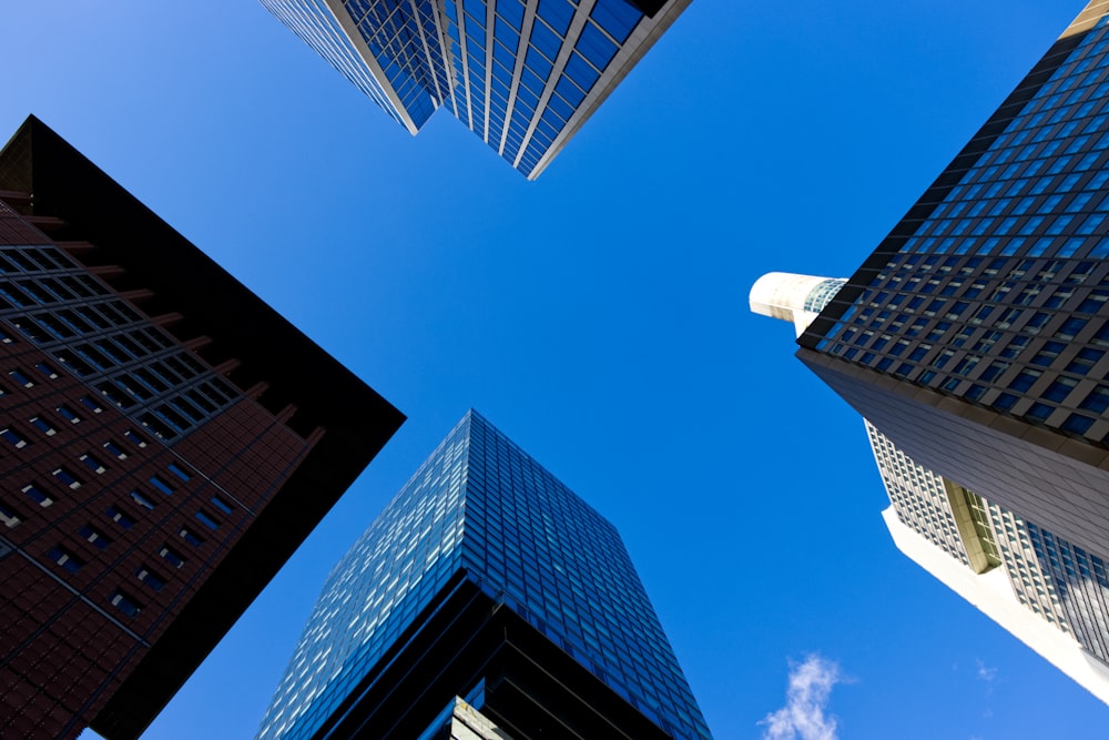 a group of tall buildings with a blue sky in the background