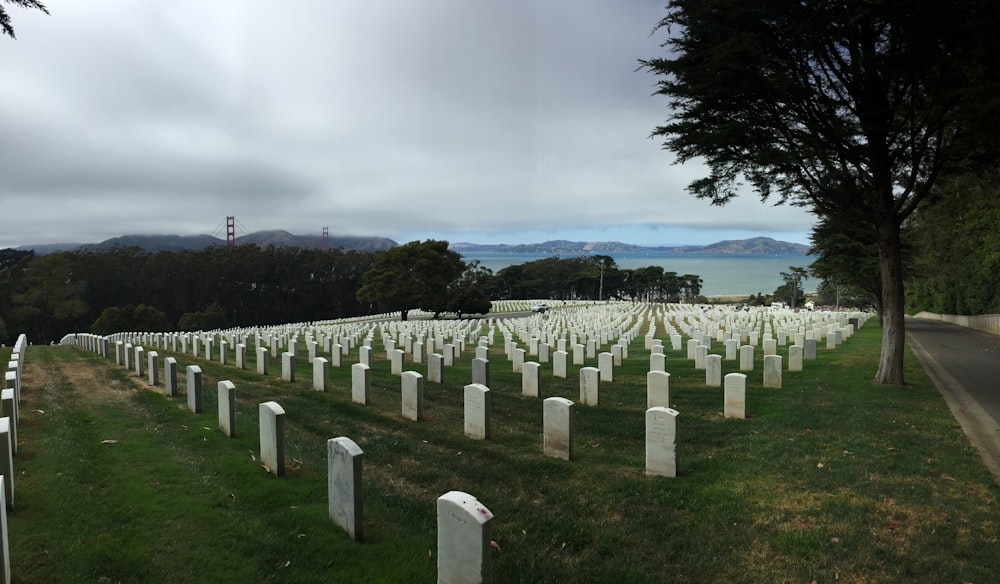 a large cemetery with many headstones in the grass