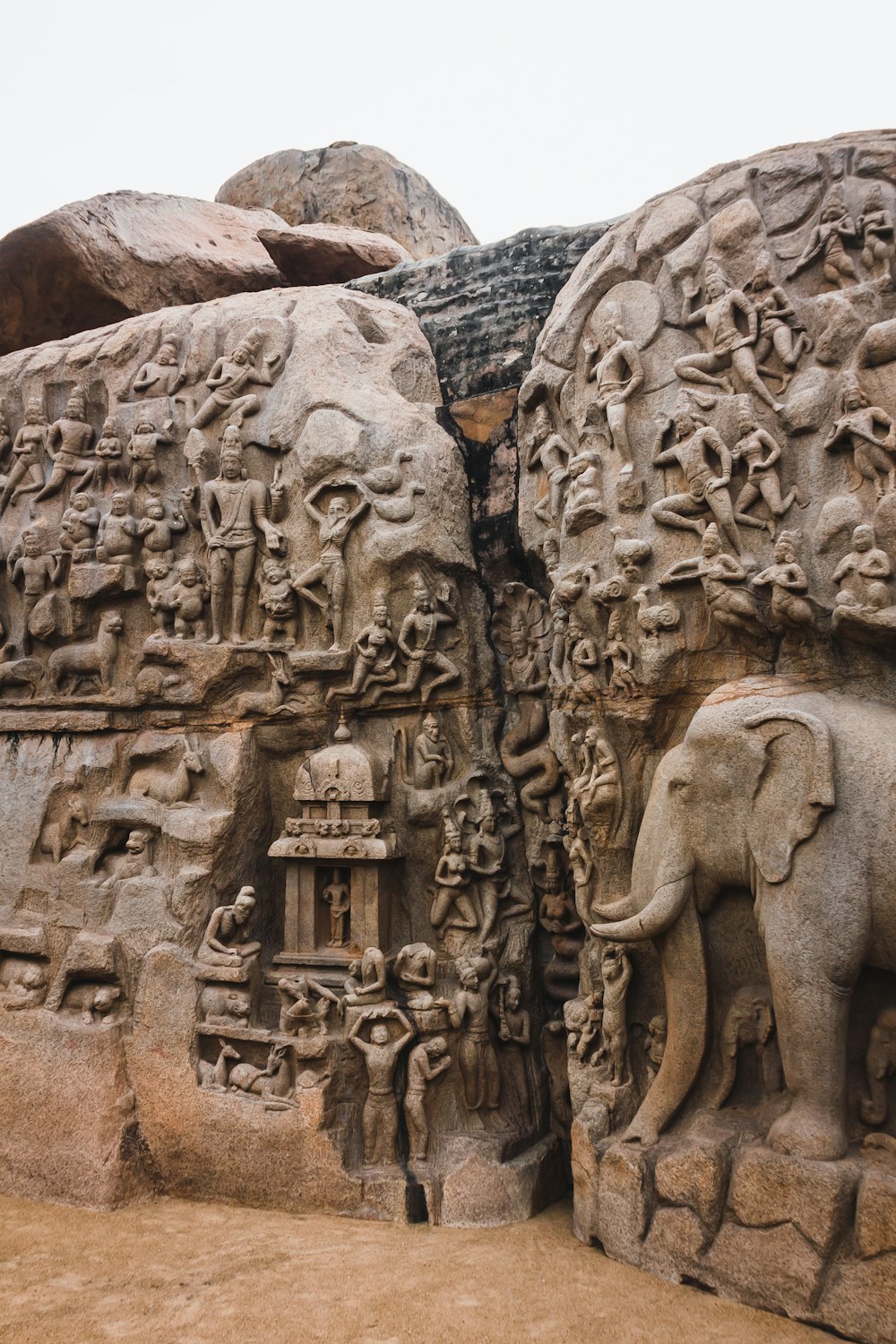 a stone carving of elephants and other animals