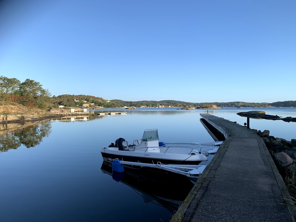 a boat docked at a dock on a lake