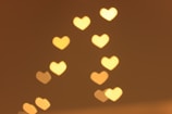 Soft glowing abstract hearts overlapping on a warm beige background.
