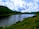 A serene landscape with a tranquil lake surrounded by lush greenery.