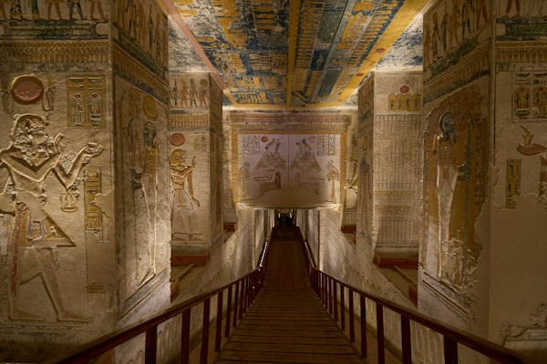 A stone staircase descending into an ancient Egyptian tomb with painted hieroglyphic walls — Sharm el-Sheikh, Egypt
