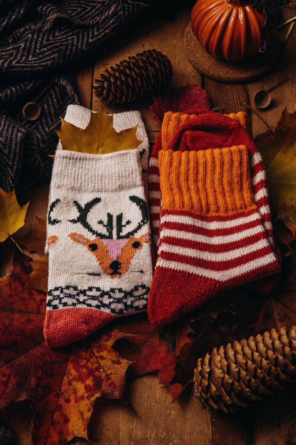 a pair of knitted socks sitting on top of a wooden table