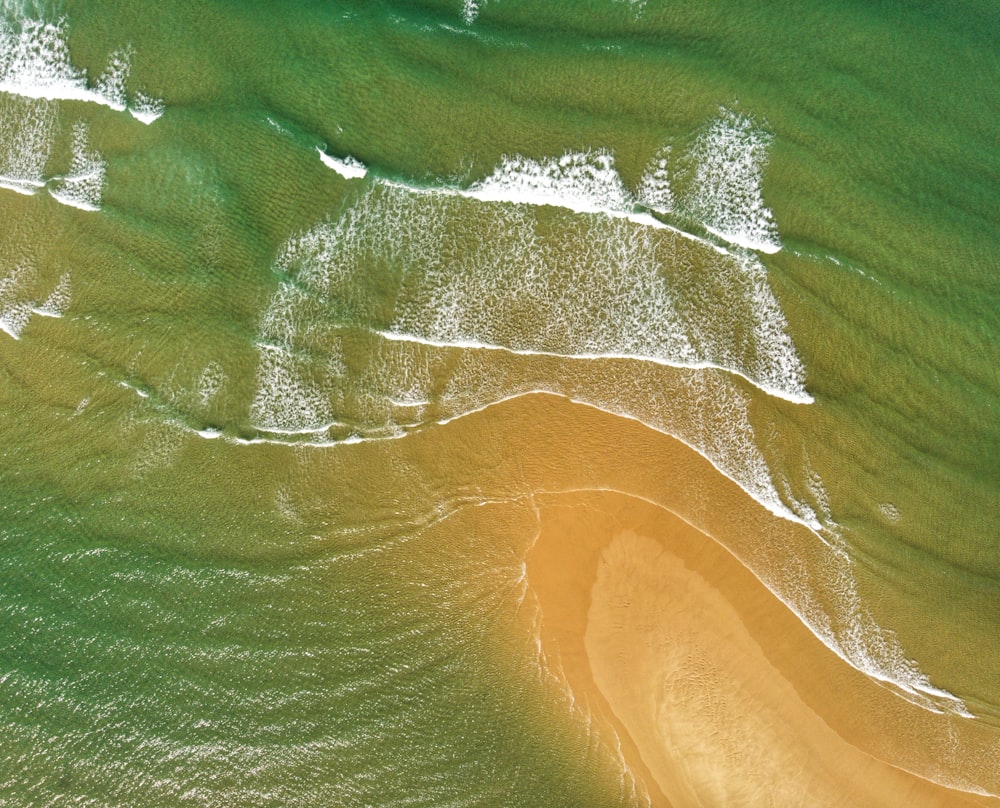 an aerial view of a sandy beach and ocean