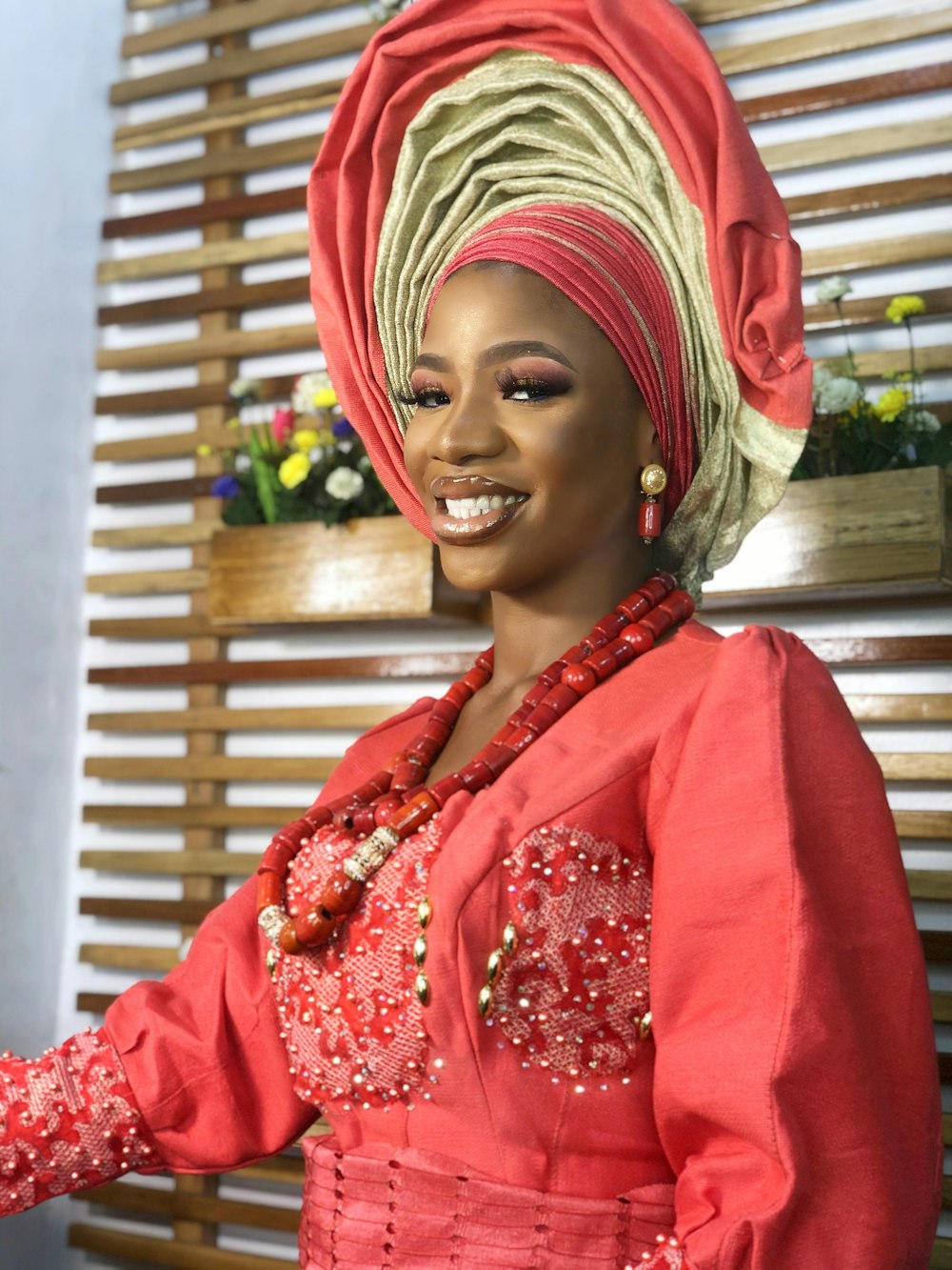 a woman in a red dress and head scarf