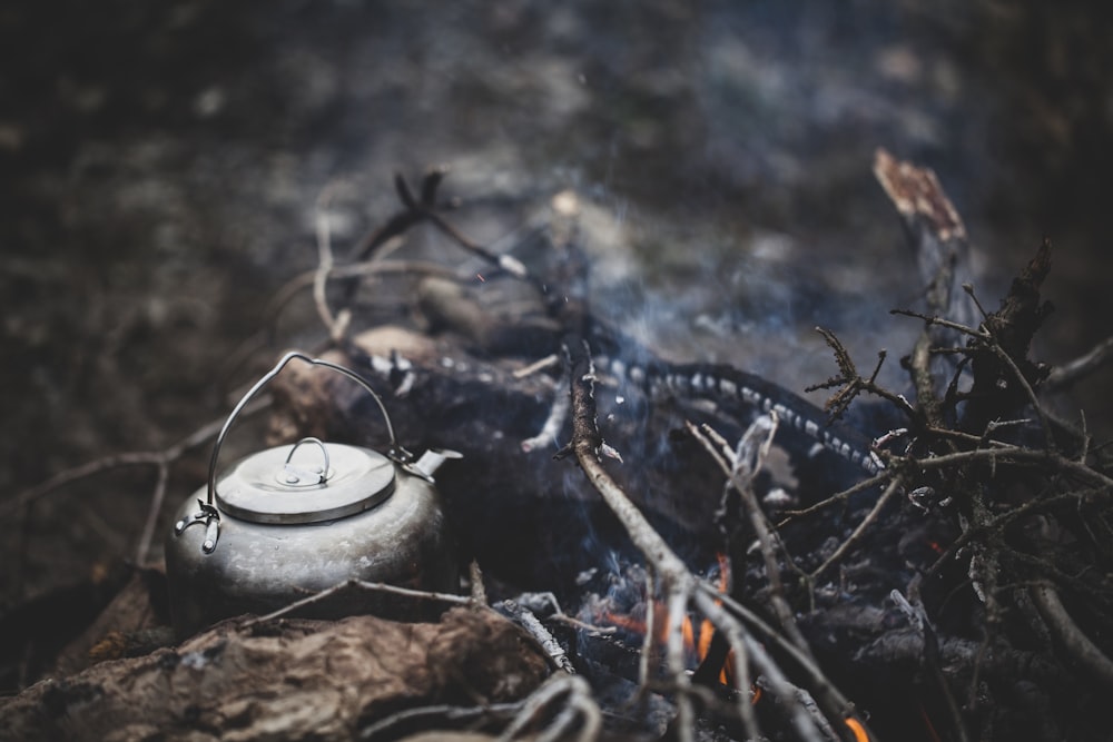 a tea pot sitting on top of a fire