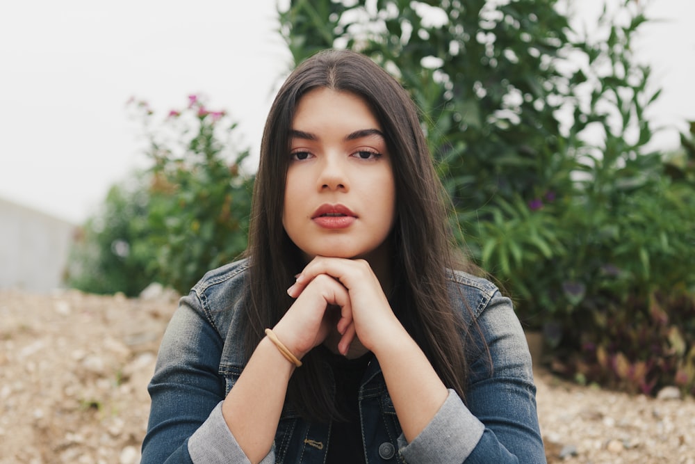 a woman with her hands on her chin