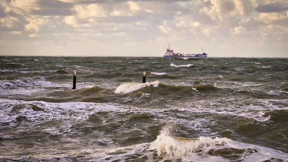 a large boat in the ocean with waves