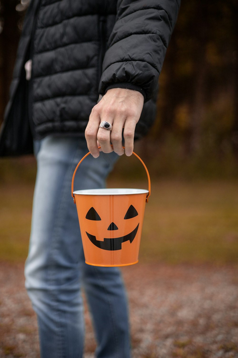 a person holding a bucket with a face painted on it
