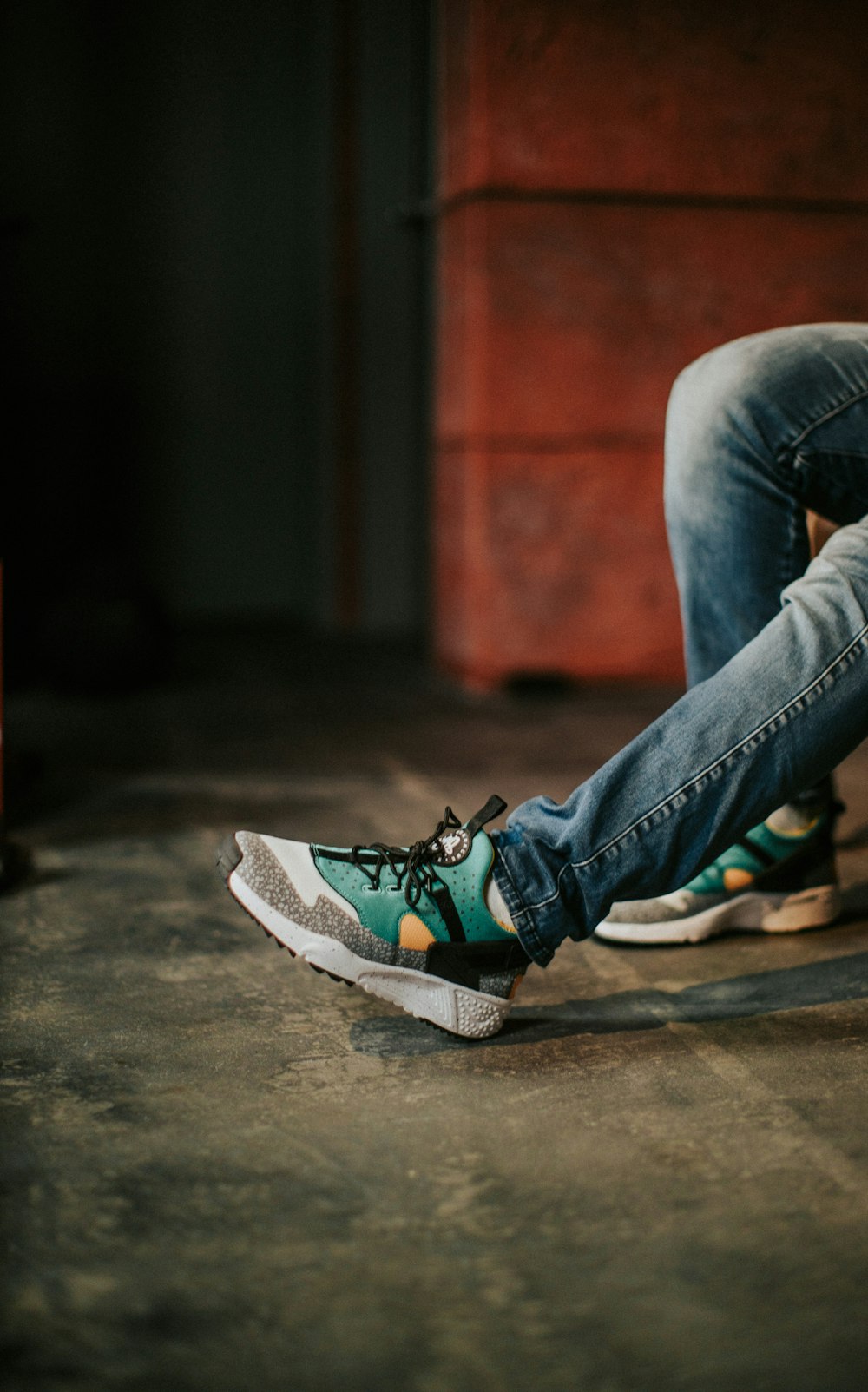 a person sitting on a skateboard on the ground