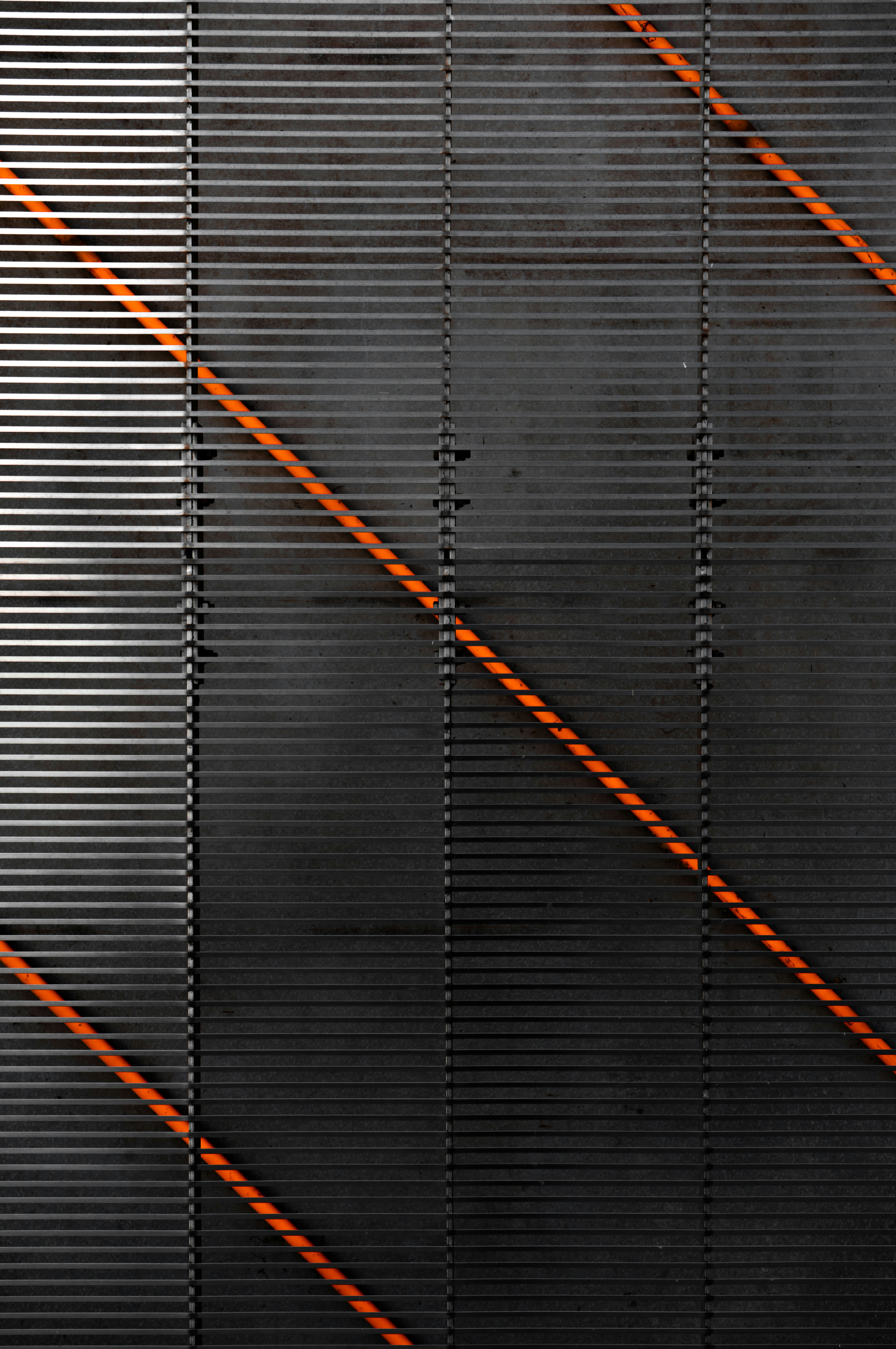 a black wall with orange lines on it
