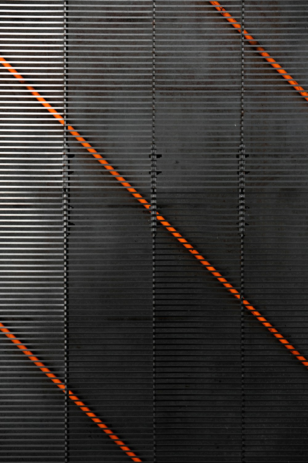 a black wall with orange lines on it