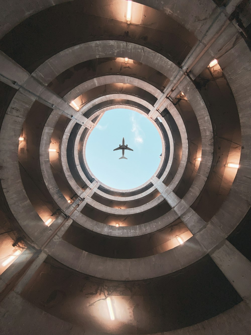 an airplane is flying through a circular structure