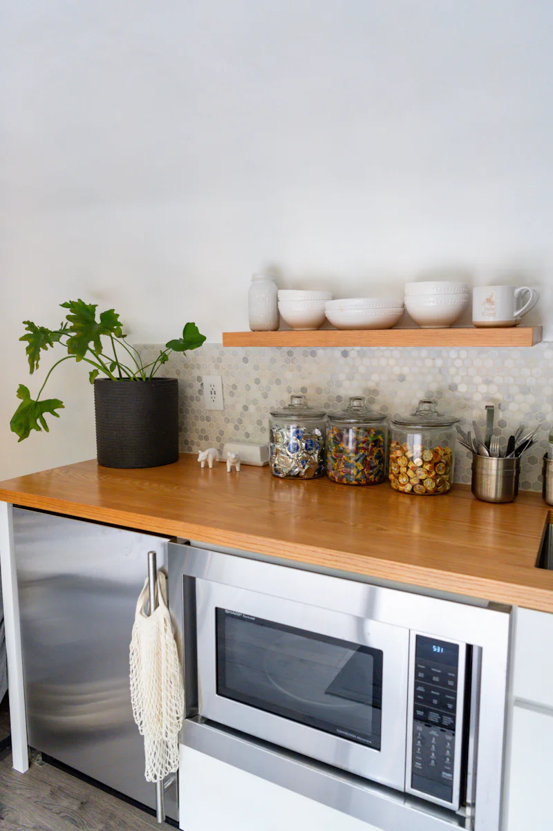 Kitchen counter with a microwave and a potted plant