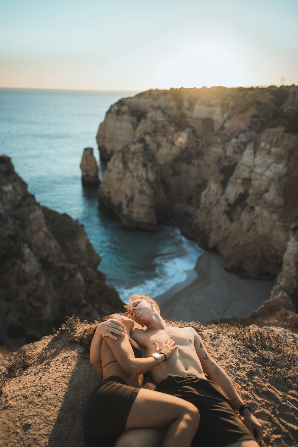 a person sitting on a rock next to water