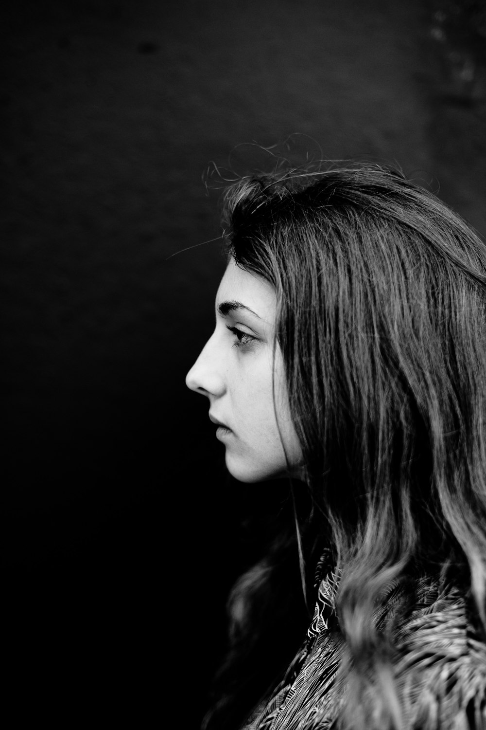 a black and white photo of a woman with long hair