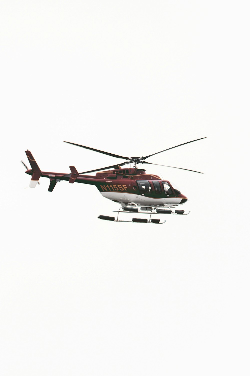 a helicopter flying in the air with a sky background