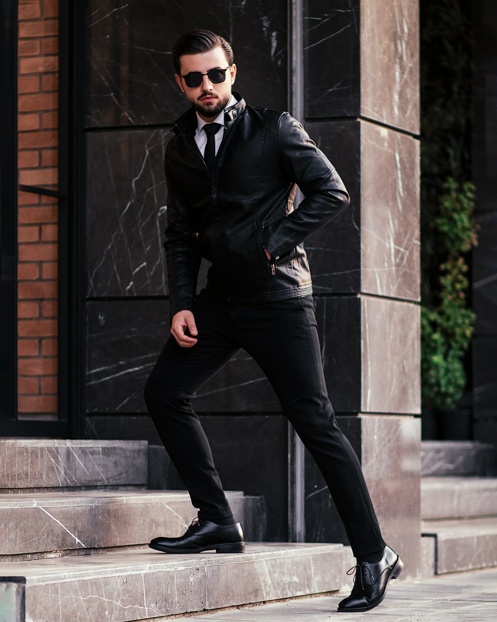 a man in a suit and tie standing on steps