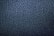 A close-up texture of dark blue or black leather with a cracked, wrinkled pattern creating an irregular and abstract appearance.