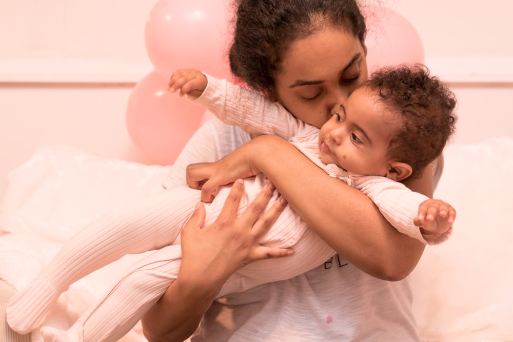 a woman holding a baby in her arms