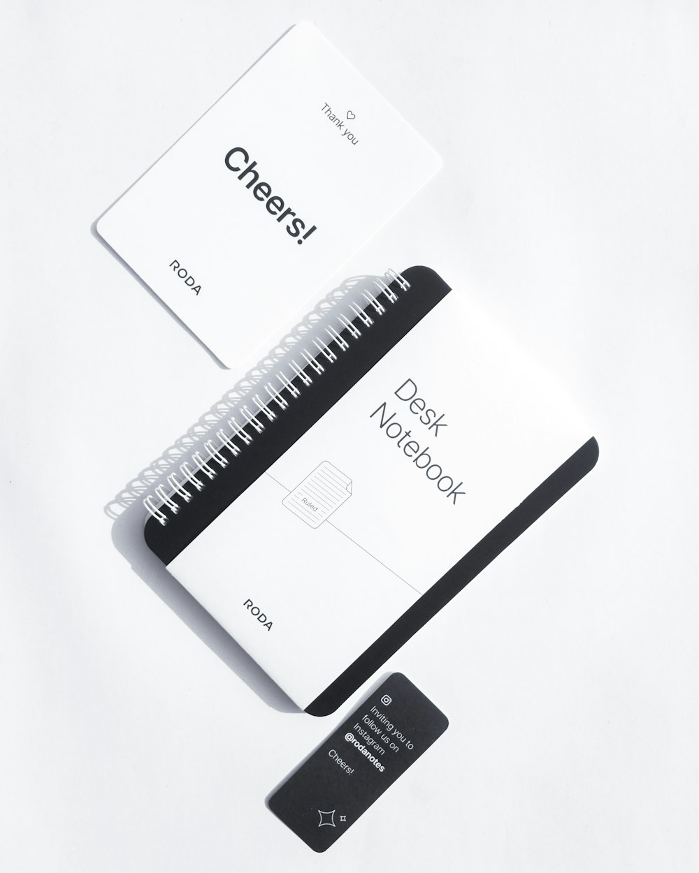 a notebook and a credit card on a white surface