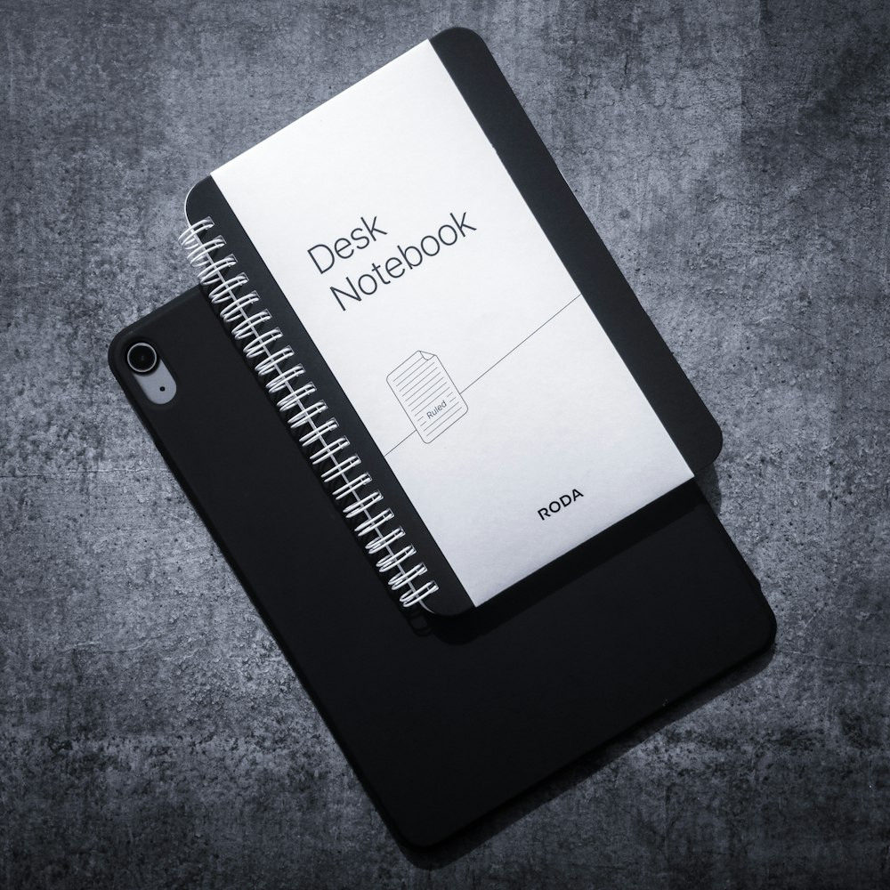 a black and white photo of a desk notebook